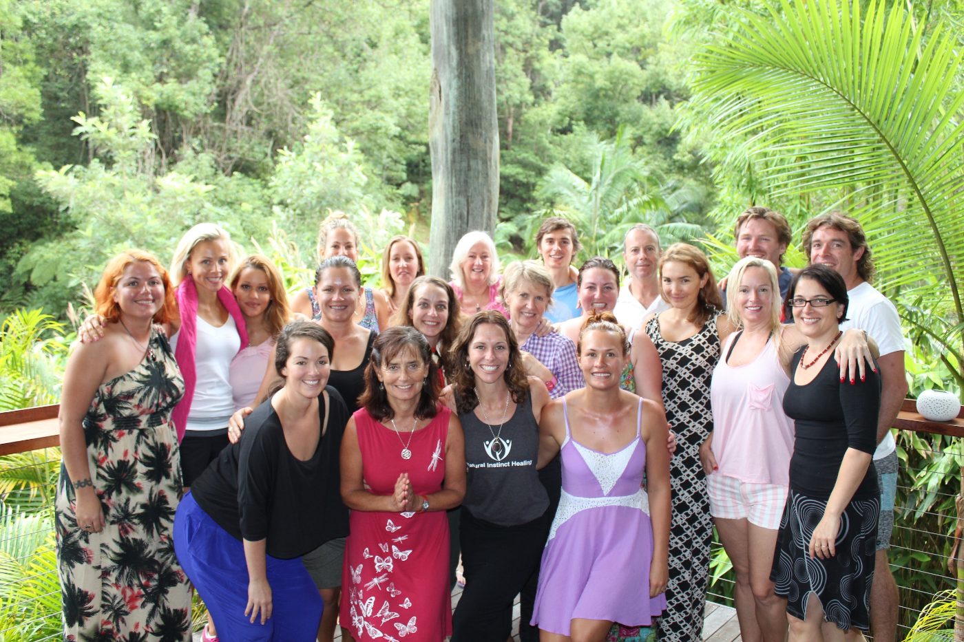 A retreat group gathered among the palms in Ubud